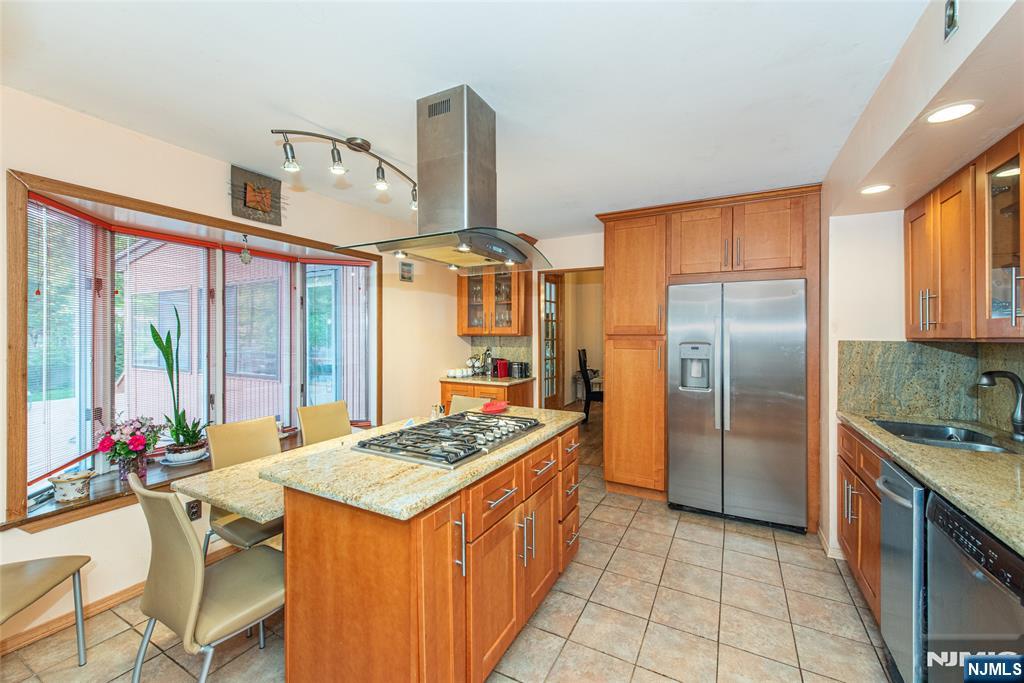 12 Abbott Road Wayne, NJ 07470 - Photo 13 of 49 a kitchen with stainless steel appliances granite countertop a sink stove and refrigerator