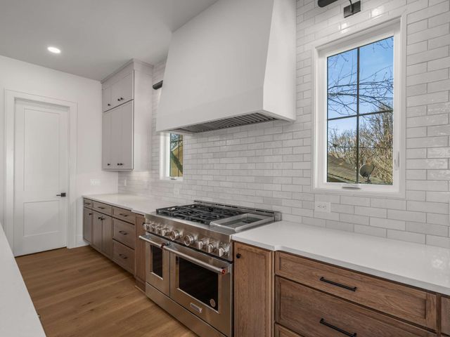 a bathroom with a sink a toilet a mirror a bathtub and shower