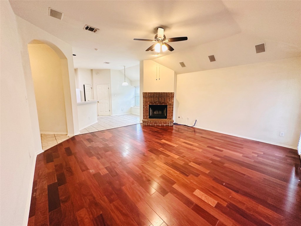 1101 Hunter's Creek Drive Cedar Park, TX 78613 - Photo 14 of 37 a view of empty room with a fireplace and wooden floor