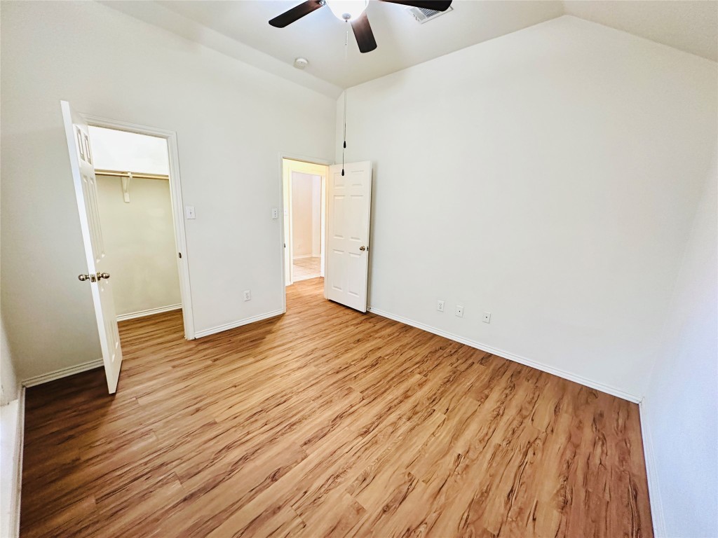 1101 Hunter's Creek Drive Cedar Park, TX 78613 - Photo 19 of 37 an empty room with wooden floor and windows