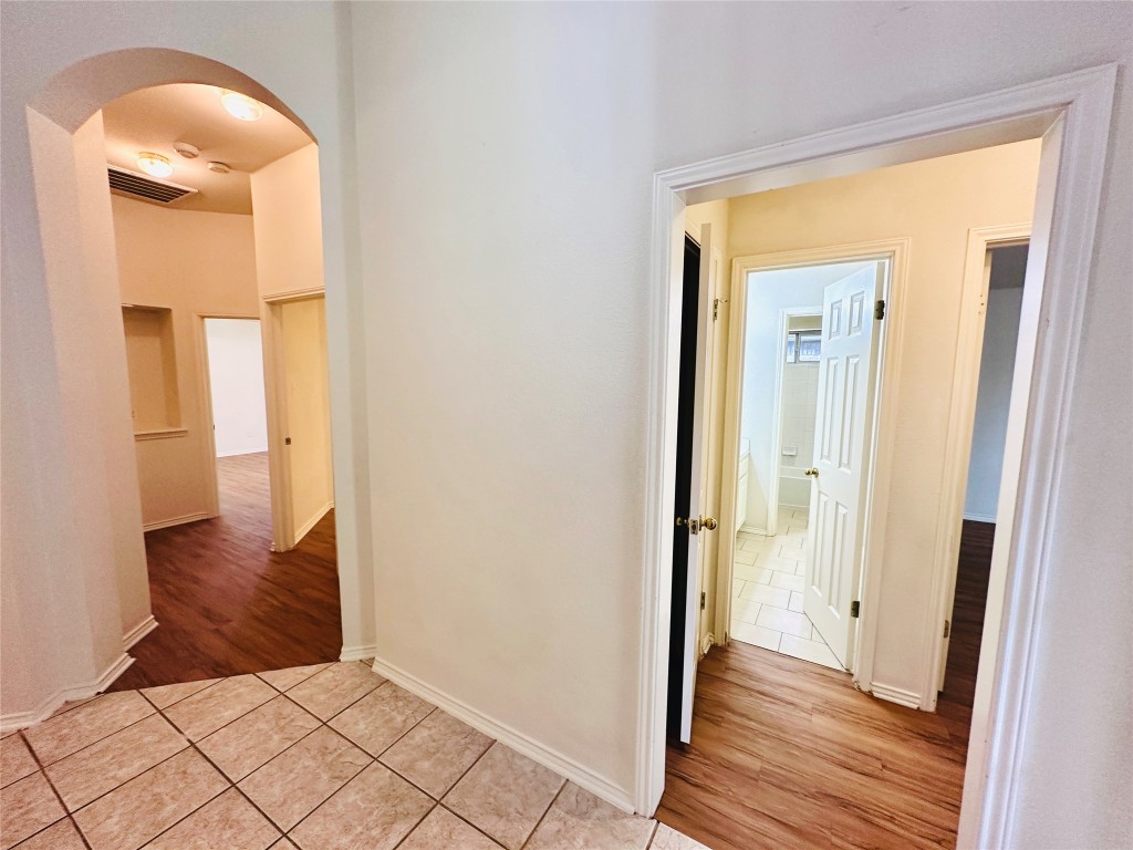 1101 Hunter's Creek Drive Cedar Park, TX 78613 - Photo 3 of 37 Hallway featuring light tile patterned flooring and arched walkways