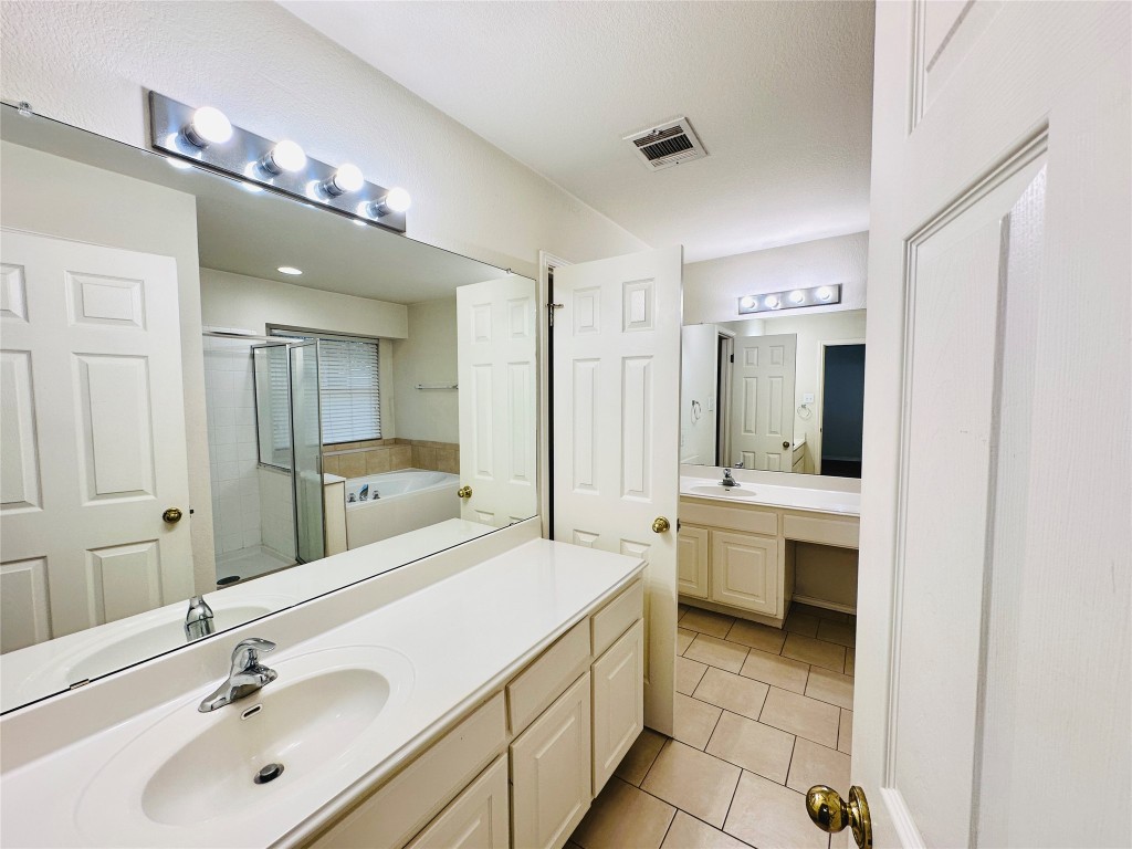 1101 Hunter's Creek Drive Cedar Park, TX 78613 - Photo 35 of 37 a bathroom with a double vanity sink mirror and bathtub