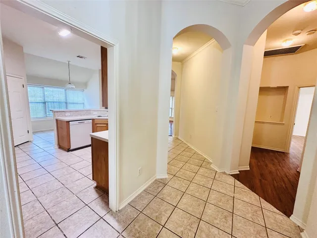 a kitchen with a refrigerator a stove top oven and cabinets