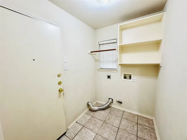 a view of empty room with a fireplace and wooden floor