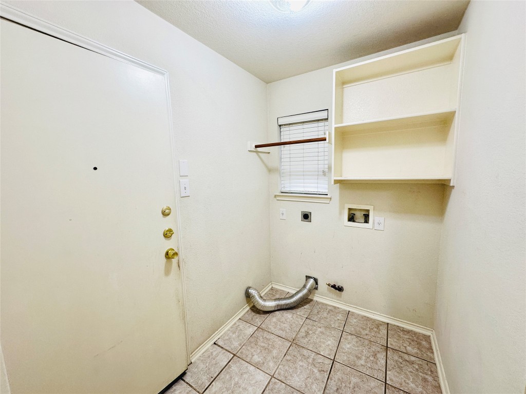 1101 Hunter's Creek Drive Cedar Park, TX 78613 - Photo 8 of 37 Laundry area featuring washer hookup, a textured ceiling, electric dryer hookup, light tile patterned flooring, and gas dryer hookup
