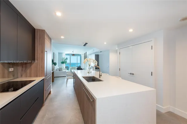 a kitchen with sink cabinets and living room