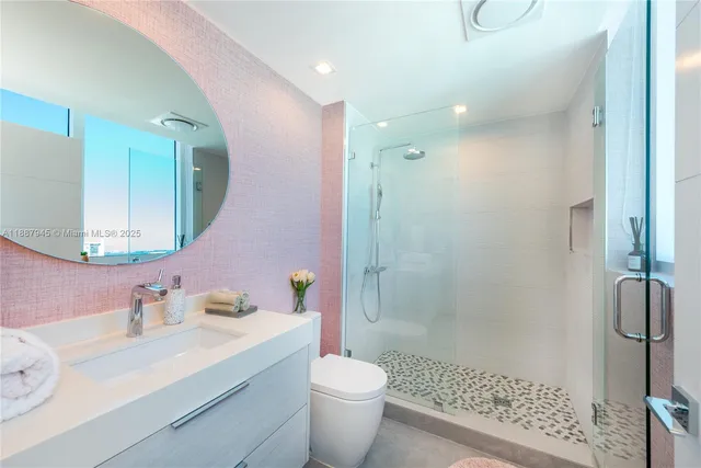 a bedroom with a large bed and a potted plant