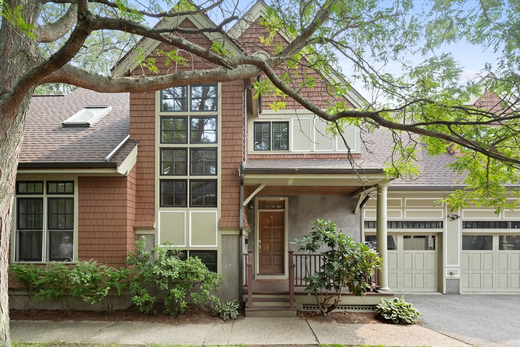 a front view of a house with plants