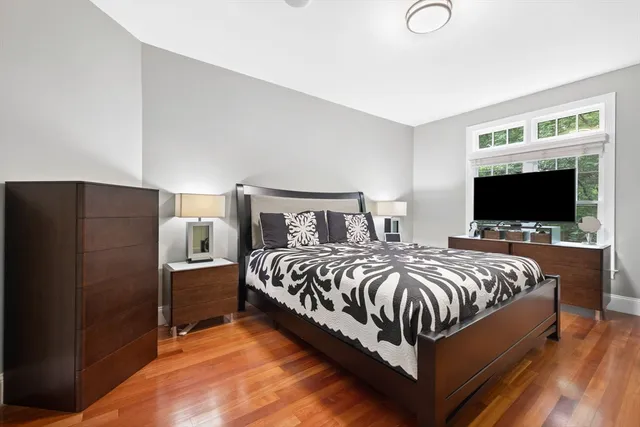 a bathroom with a granite countertop sink toilet a mirror and next to a window