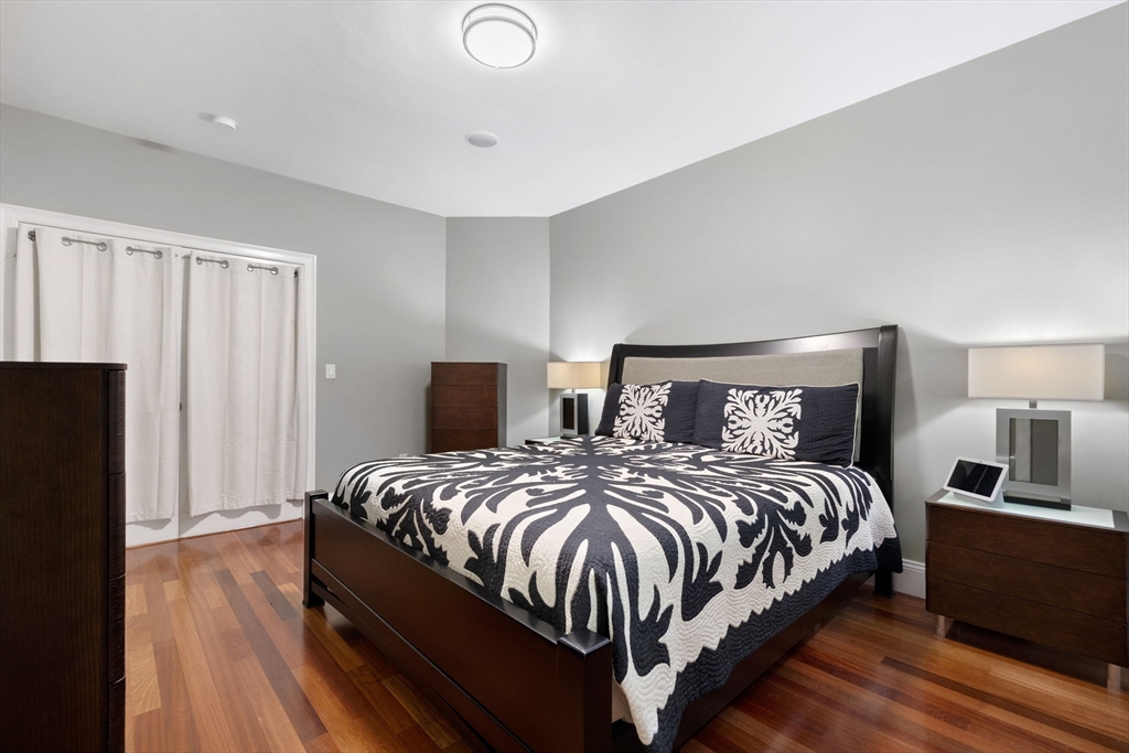 20 Hamlet Street, Unit 1 Newton, MA 02459 - Photo 17 of 41 a bedroom with a bed and wooden floor