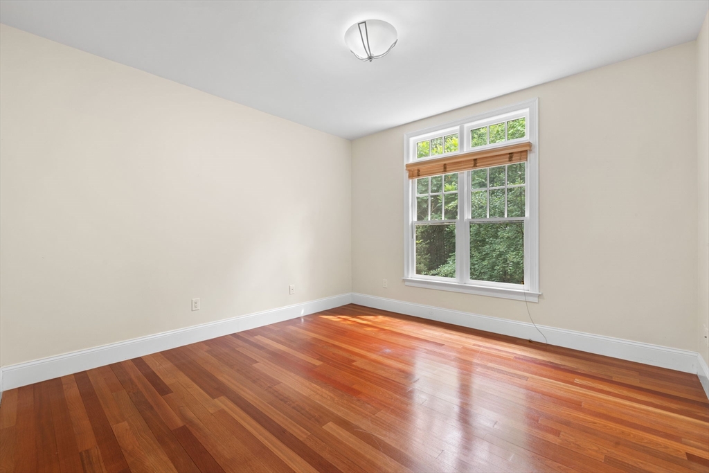20 Hamlet Street, Unit 1 Newton, MA 02459 - Photo 25 of 41 an empty room with wooden floor and windows