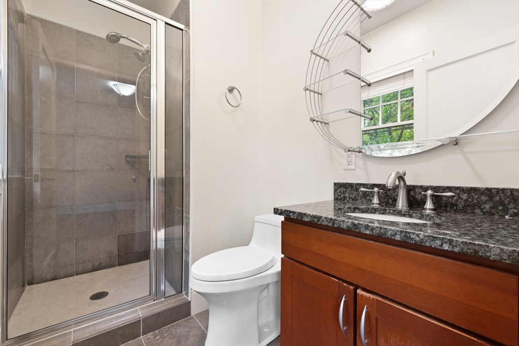 20 Hamlet Street, Unit 1 Newton, MA 02459 - Photo 27 of 41 a bathroom with a granite countertop sink a toilet and shower