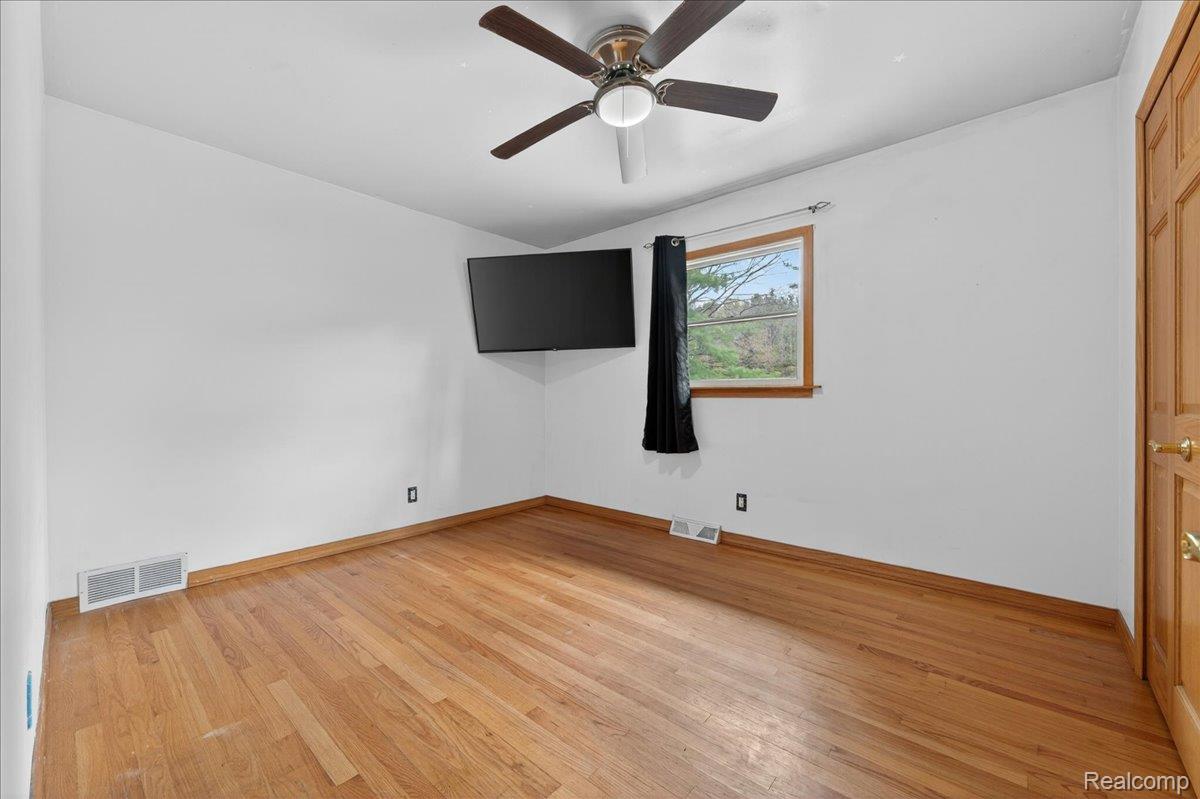 4049 Slattery Road North Branch, MI 48461 - Photo 21 of 45 Unfurnished bedroom with light wood-type flooring and a ceiling fan