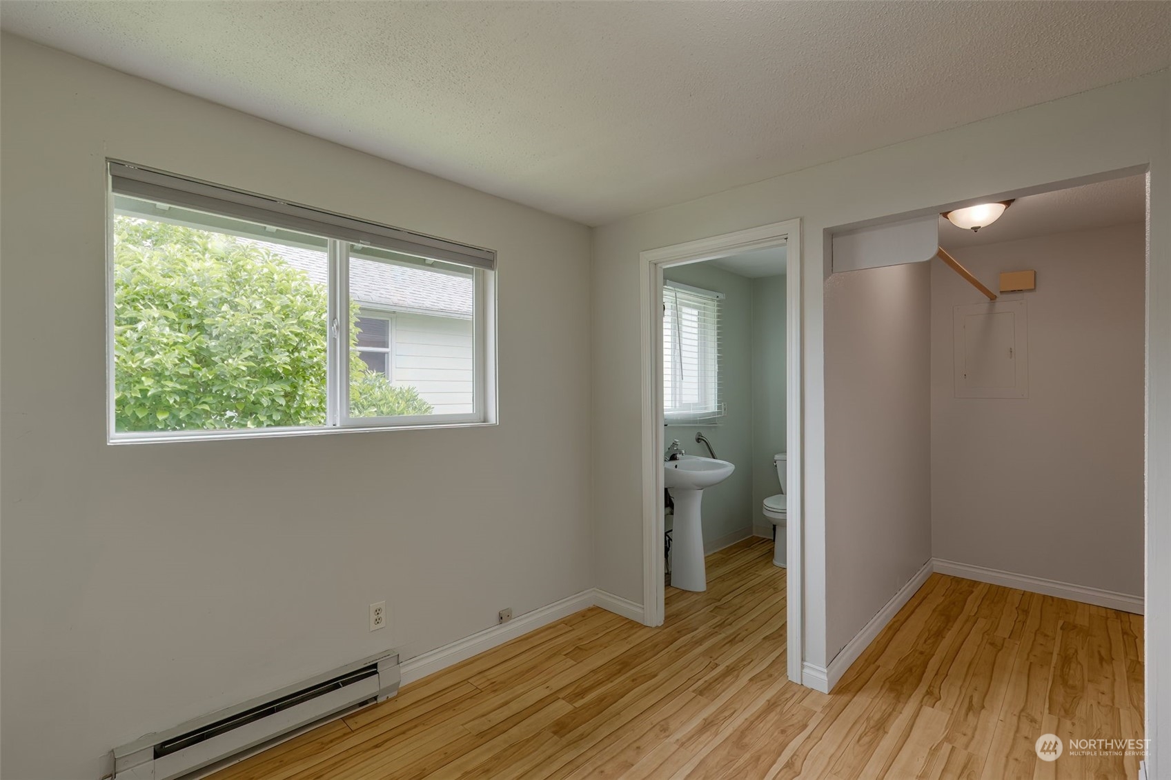 805 8th Avenue Longview, WA 98632 - Photo 15 of 32 a view of hallway with a bed and wooden floor