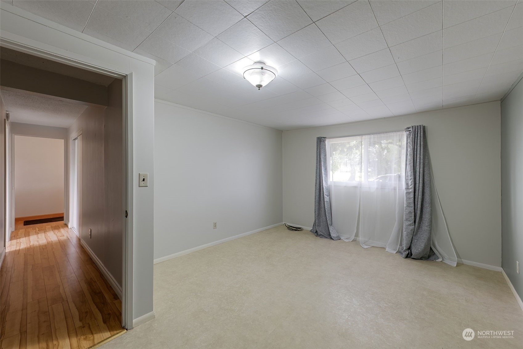 805 8th Avenue Longview, WA 98632 - Photo 22 of 32 a view of an empty room with wooden floor and a window