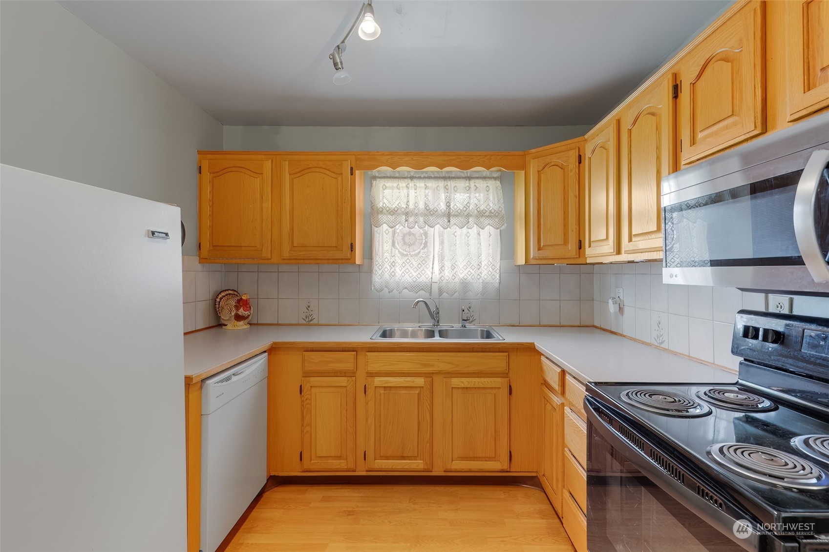 805 8th Avenue Longview, WA 98632 - Photo 7 of 32 a kitchen with a sink stove top oven and cabinets