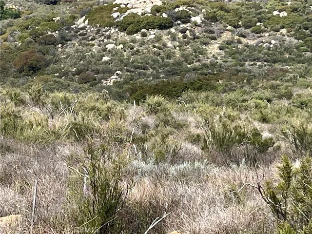a view of a large mountain with mountains in the background
