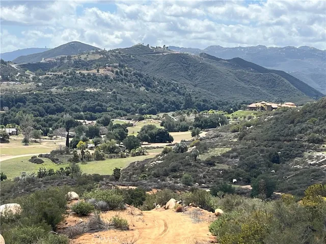 a view of a town with mountains in the background