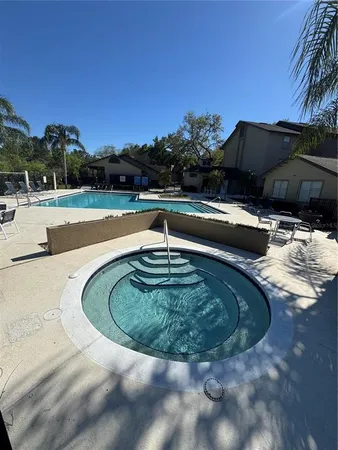 a view of a swimming pool with a yard