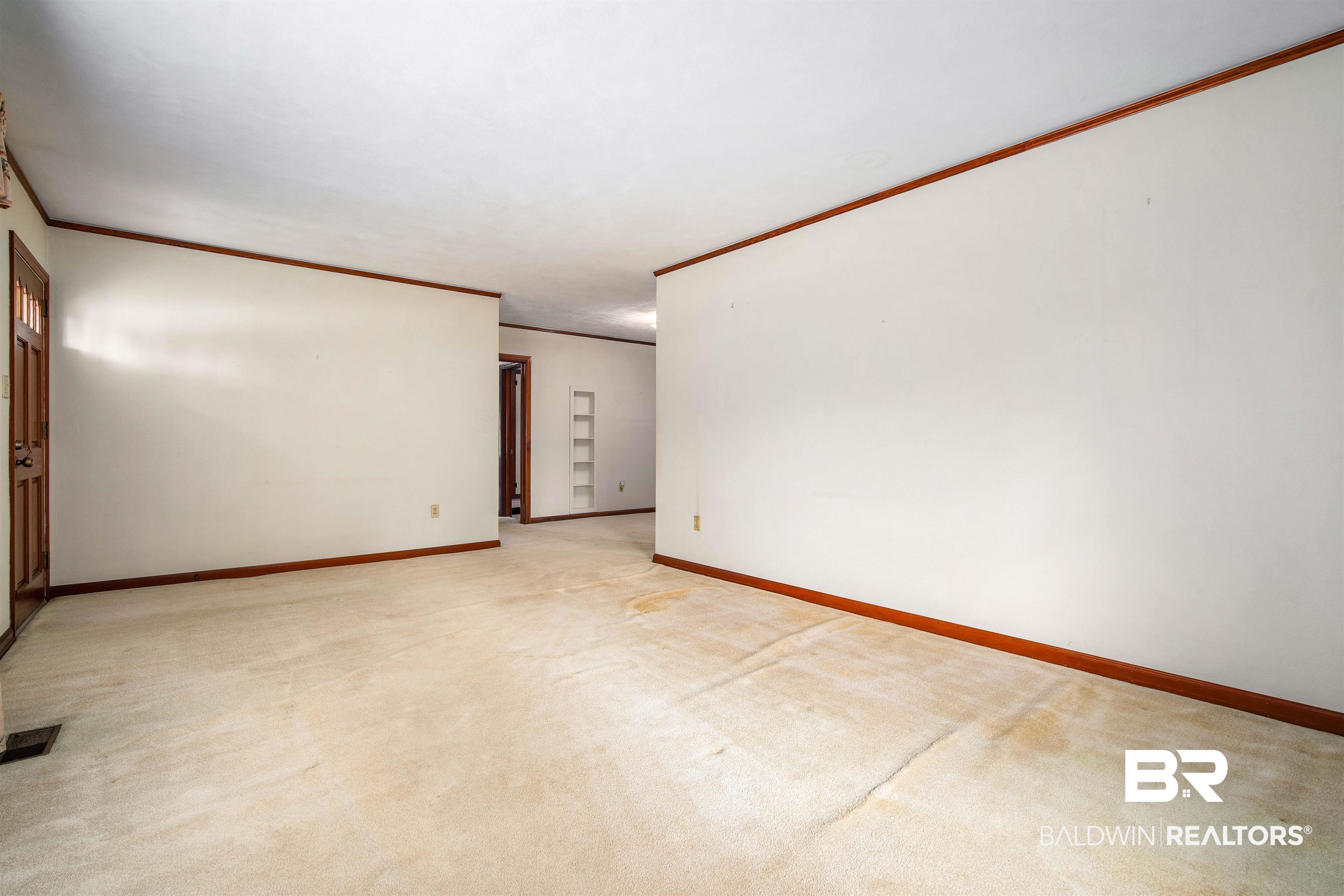 2300 Ellen Drive Mobile, AL 36605 - Photo 12 of 25 Carpeted spare room featuring crown molding