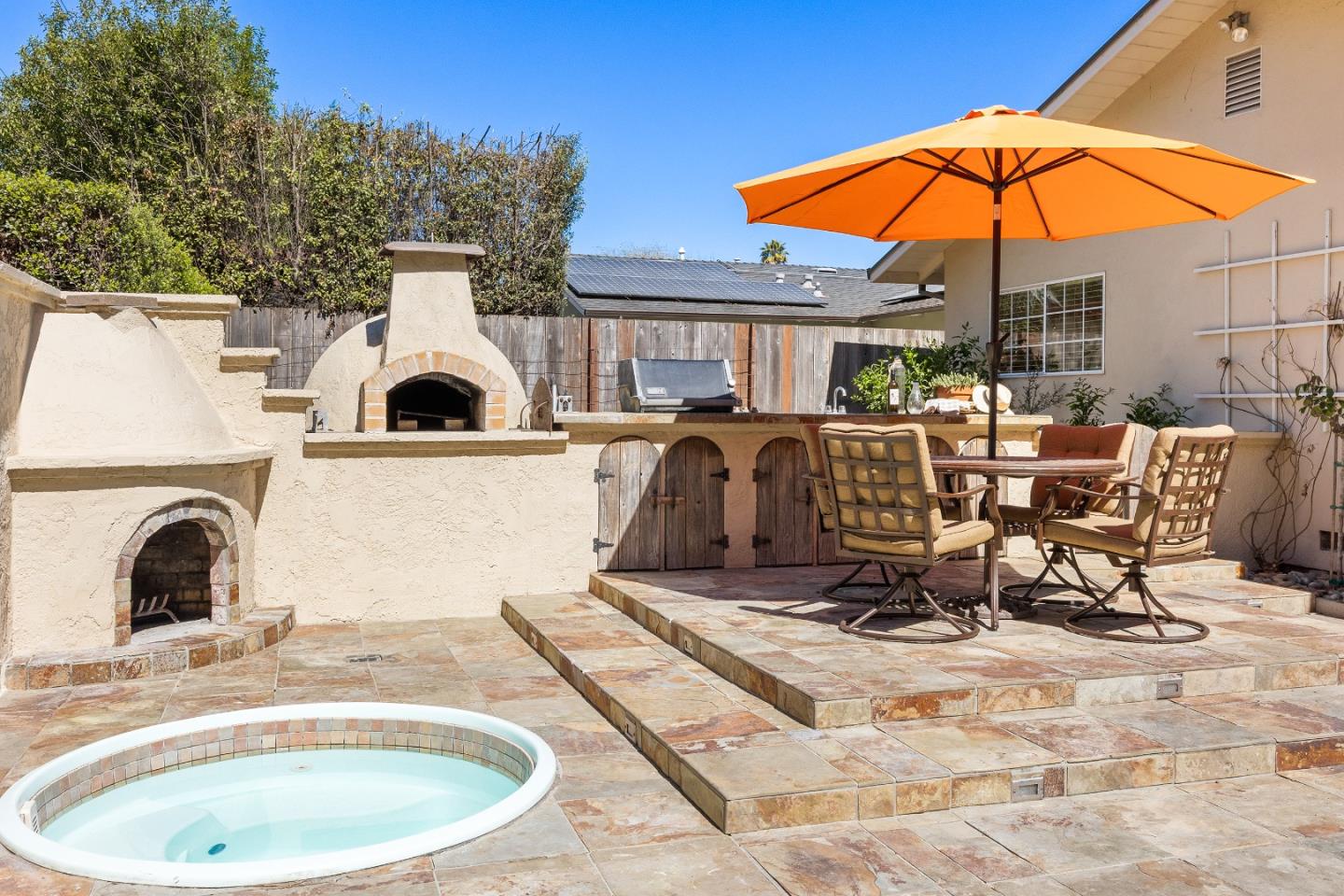 105 Wesley Street Capitola, CA 95010 - Photo 43 of 55 a view of a patio with a table and chairs under an umbrella