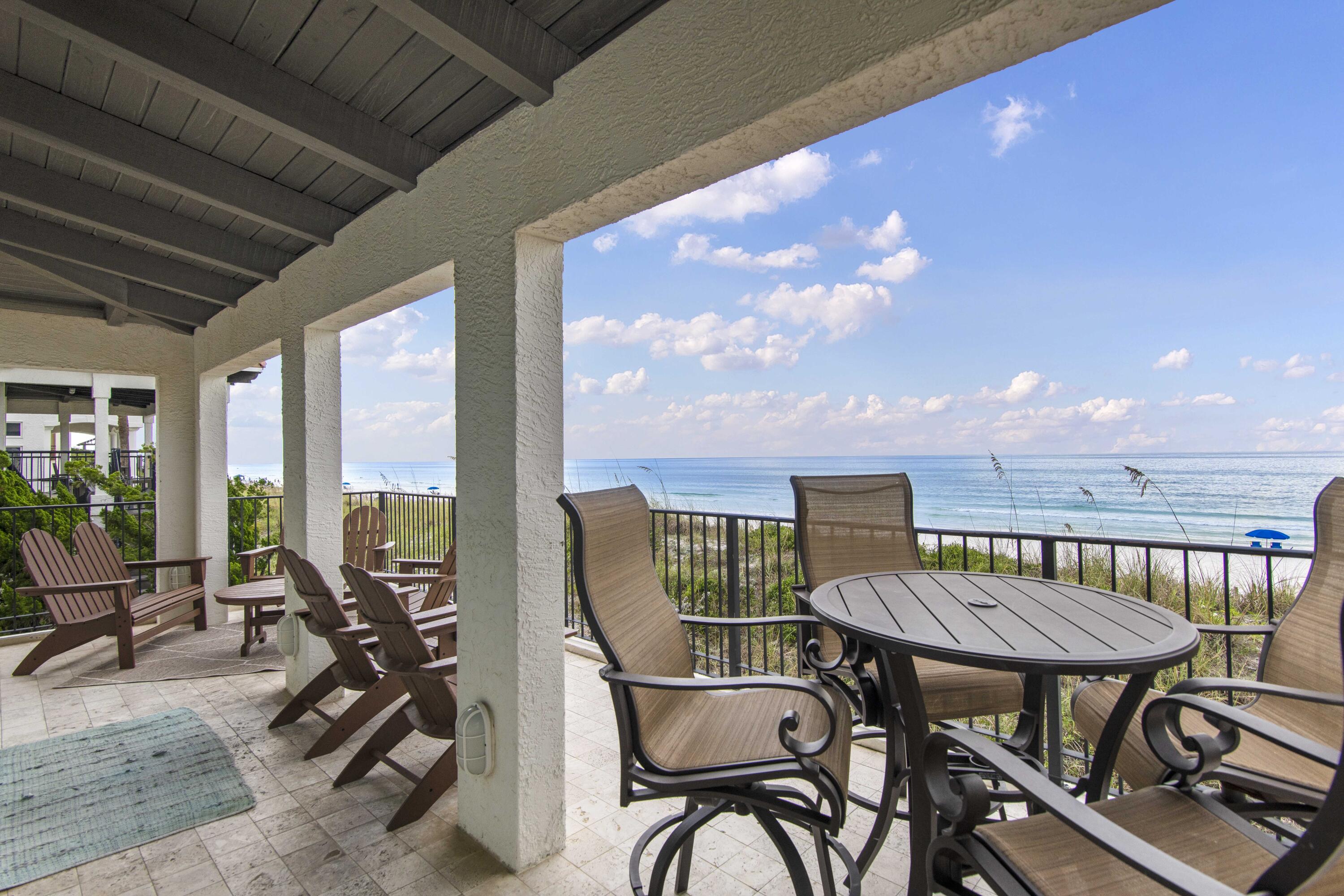 5055 West County Highway 30A, Unit 1011 Santa Rosa Beach, FL 32459 - Photo 5 of 8 a view of a chairs and table in patio