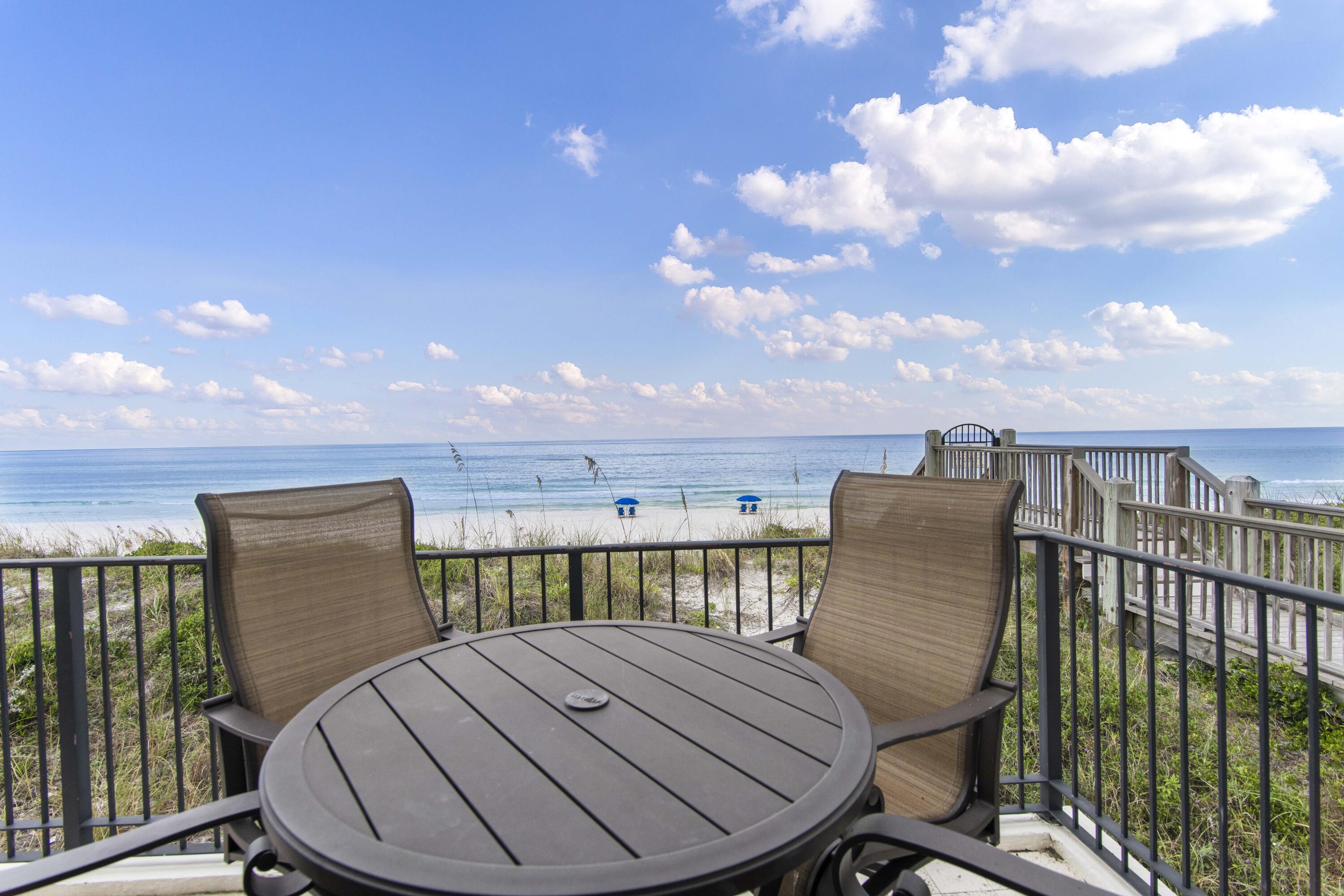 5055 West County Highway 30A, Unit 1011 Santa Rosa Beach, FL 32459 - Photo 6 of 8 a view of a roof deck with chair and wooden floor