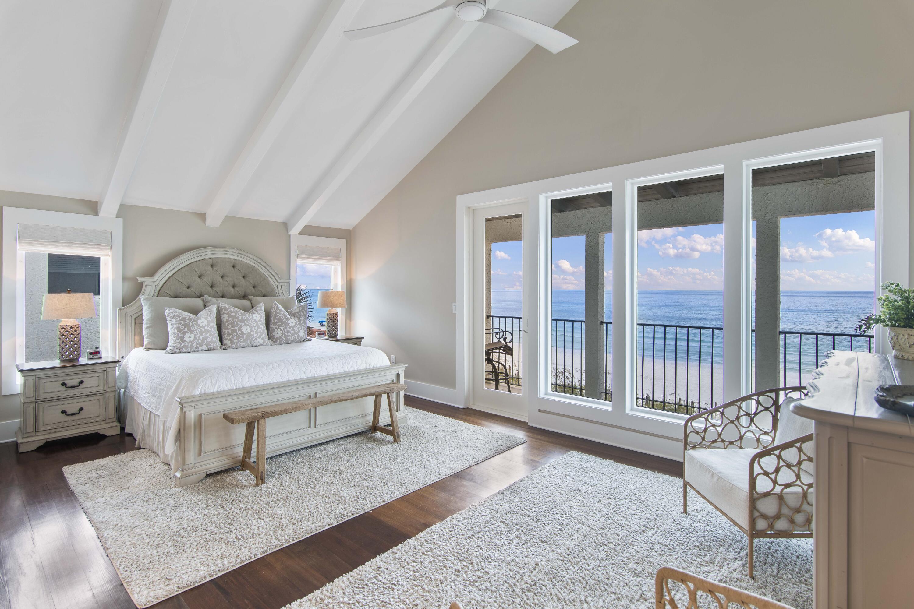 5055 West County Highway 30A, Unit 1011 Santa Rosa Beach, FL 32459 - Photo 7 of 8 a spacious bedroom with a bed a table and large window