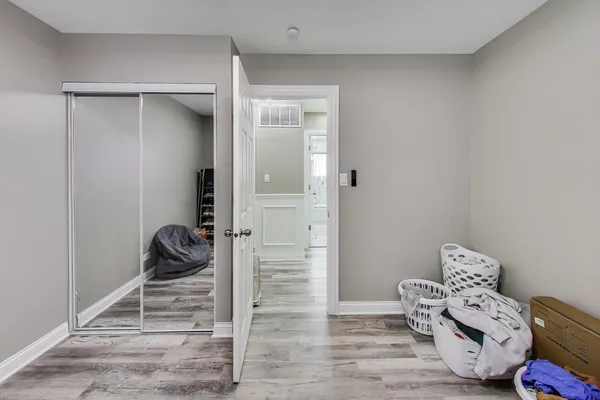 a room with a baby crib and a dresser