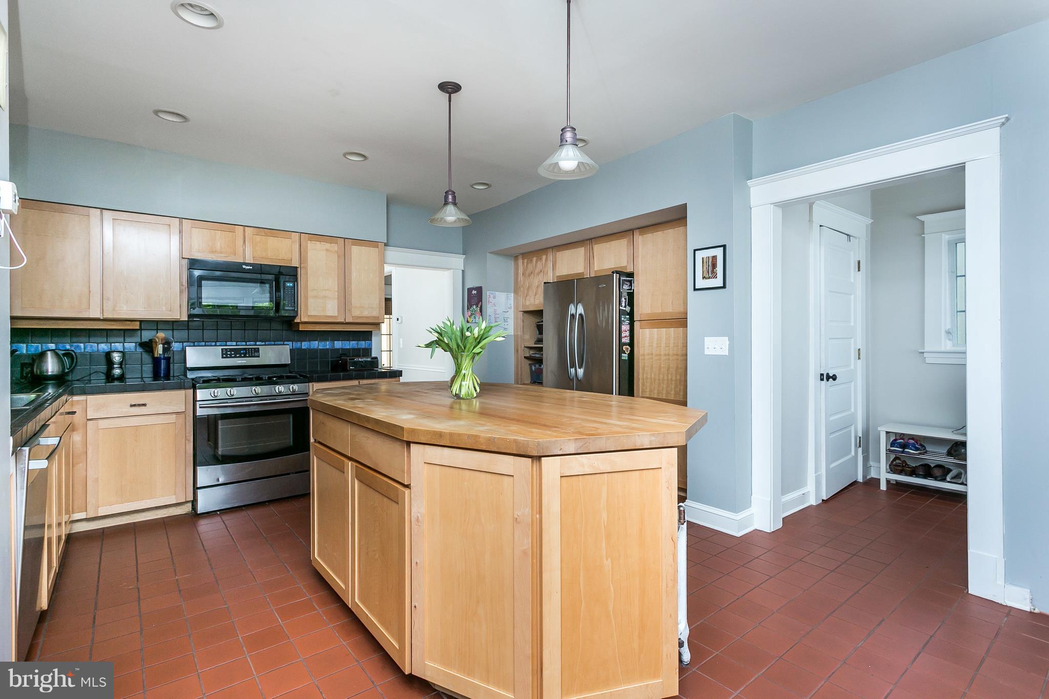 6204 Pinehurst Road Baltimore, MD 21212 - Photo 11 of 29 a kitchen with kitchen island granite countertop stainless steel appliances and wooden floor