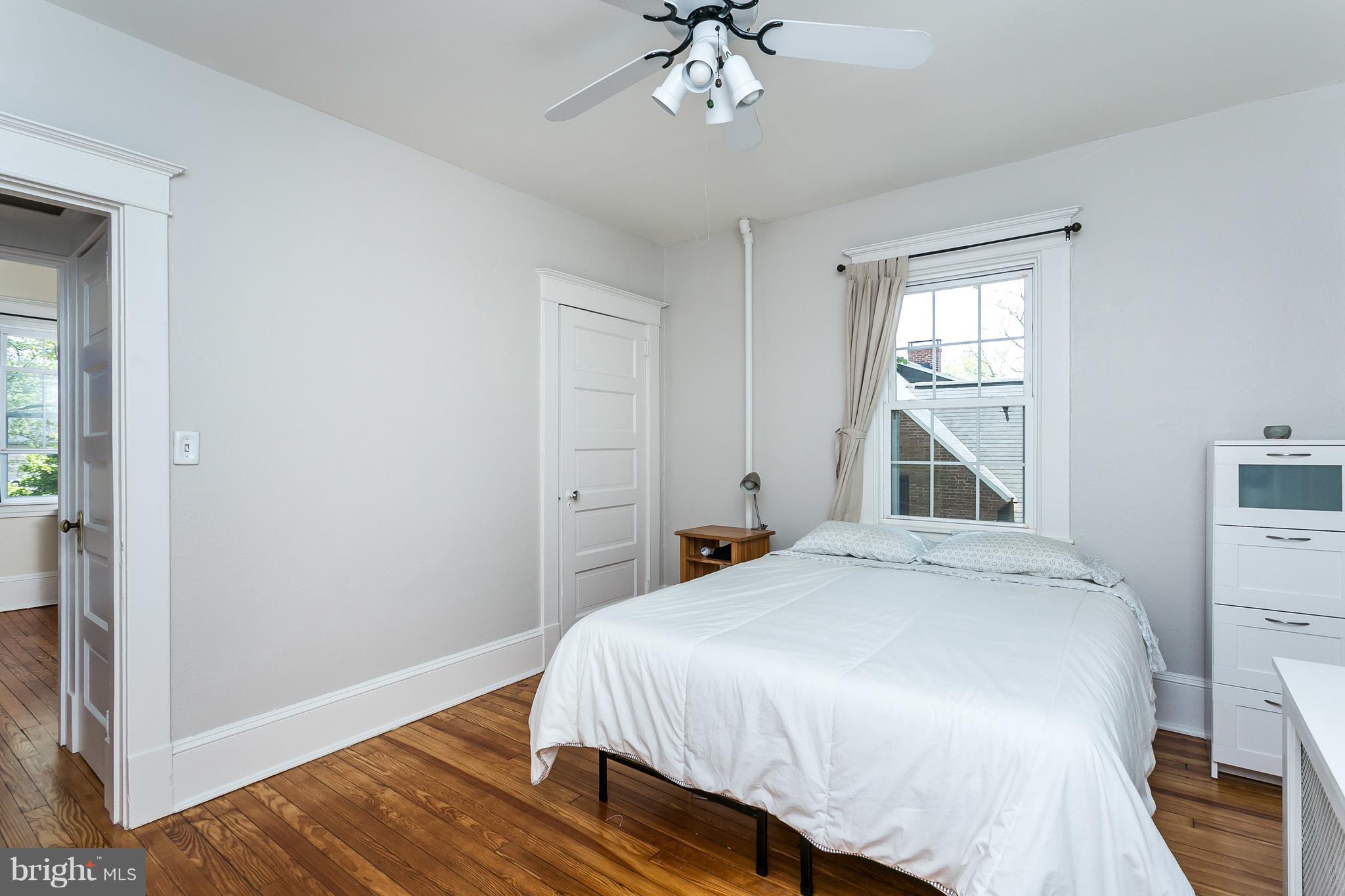 6204 Pinehurst Road Baltimore, MD 21212 - Photo 15 of 29 a bedroom with a bed and a chandelier