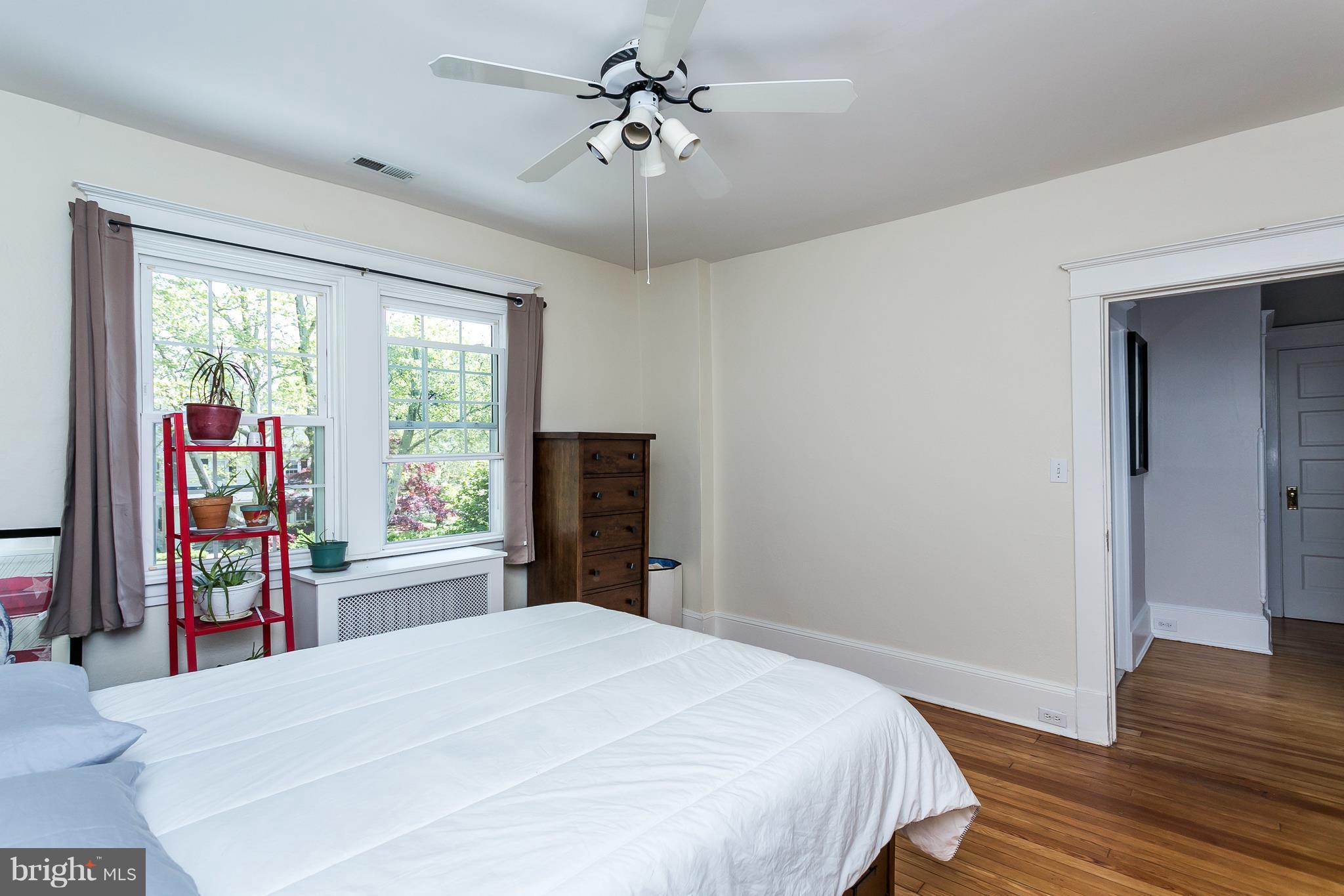 6204 Pinehurst Road Baltimore, MD 21212 - Photo 17 of 29 a bedroom with a bed and a chandelier