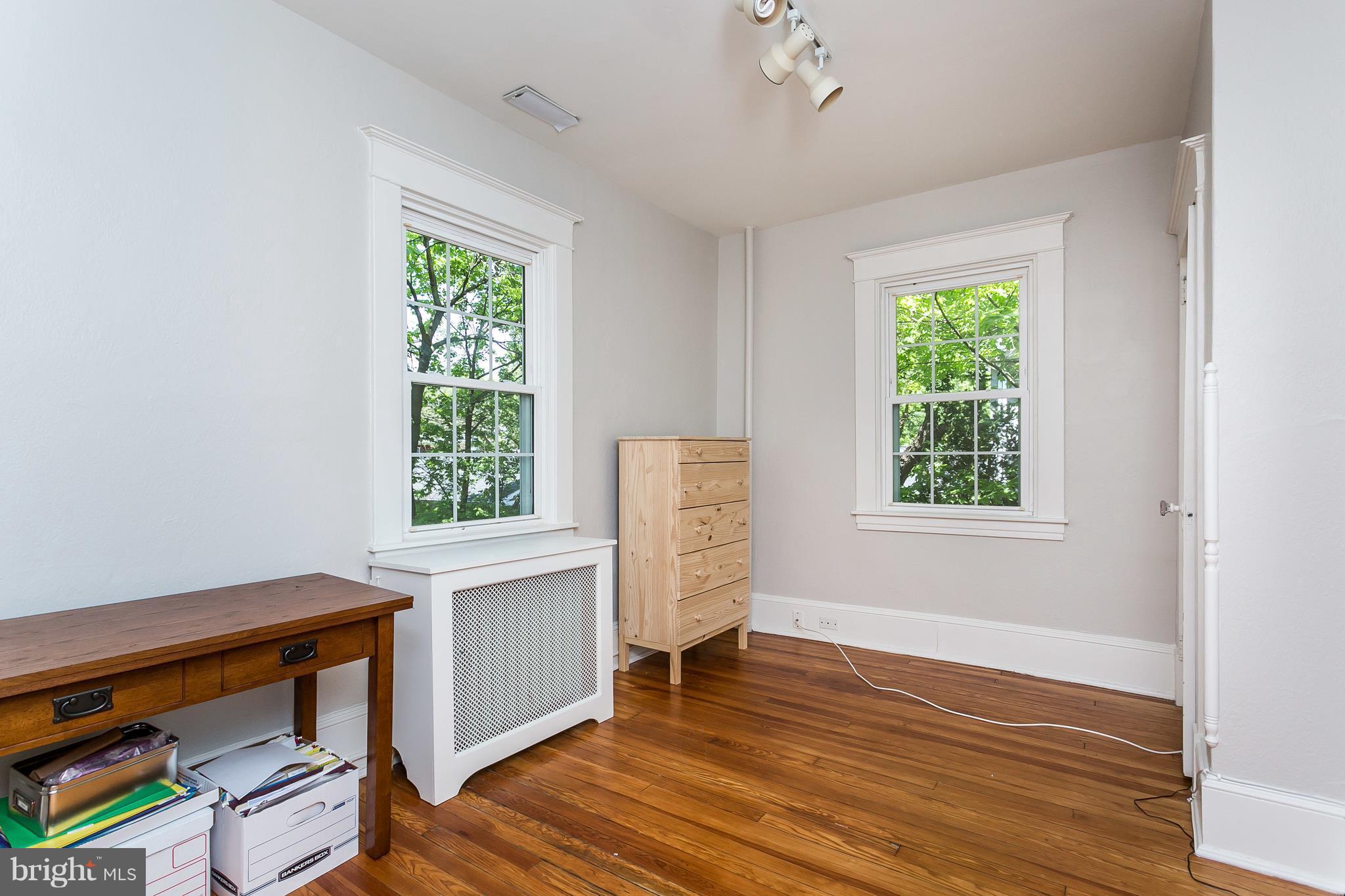 6204 Pinehurst Road Baltimore, MD 21212 - Photo 20 of 29 a view of an empty room with a window and wooden floor