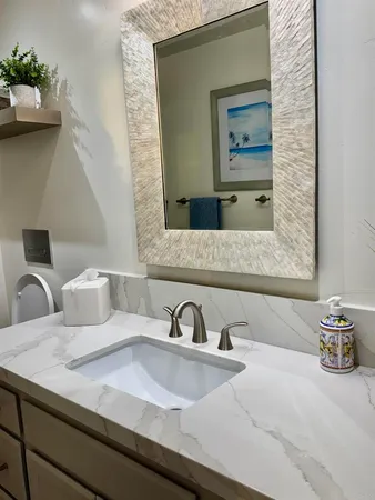 a bathroom with a toilet a sink and shower