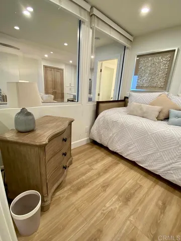 a bedroom with a bed and a mirror