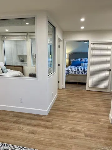 a view of a room with wooden floor and cabinet