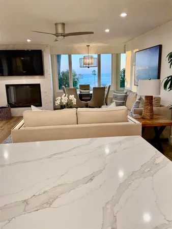 a kitchen with stainless steel appliances granite countertop a table chairs and wooden cabinets