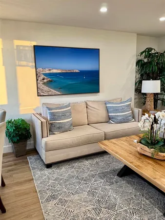 a kitchen with stainless steel appliances granite countertop a table chairs sink and white cabinets