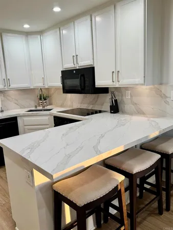 a large bed sitting in a bedroom next to a lamp