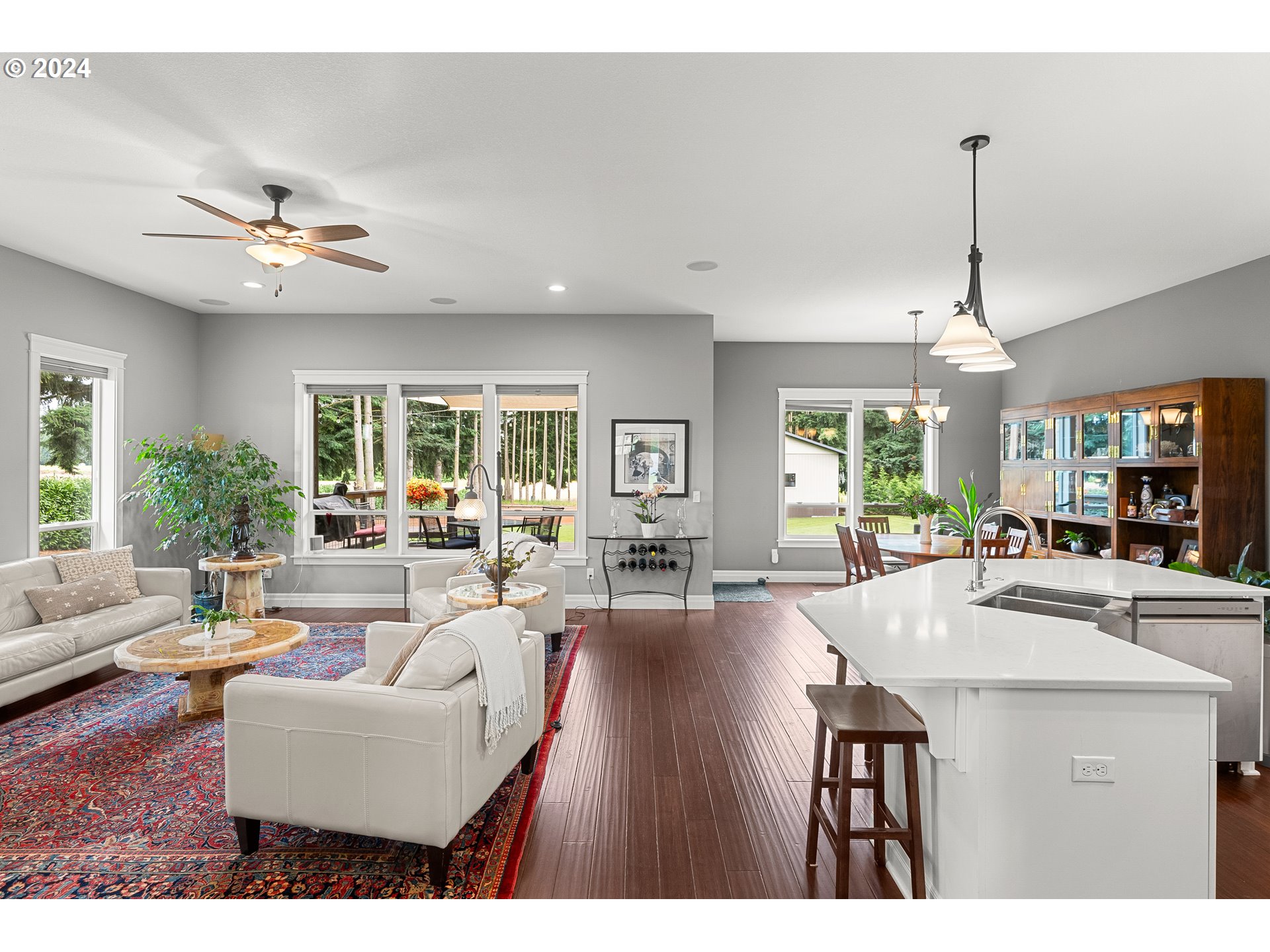 25595 South Rhoten Road Aurora, OR 97002 - Photo 11 of 48 a living room with furniture a dining table and a chandelier
