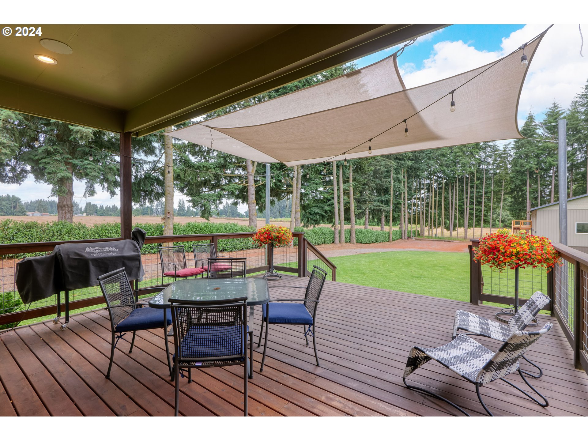 25595 South Rhoten Road Aurora, OR 97002 - Photo 20 of 48 a view of chairs and table in patio with a yard