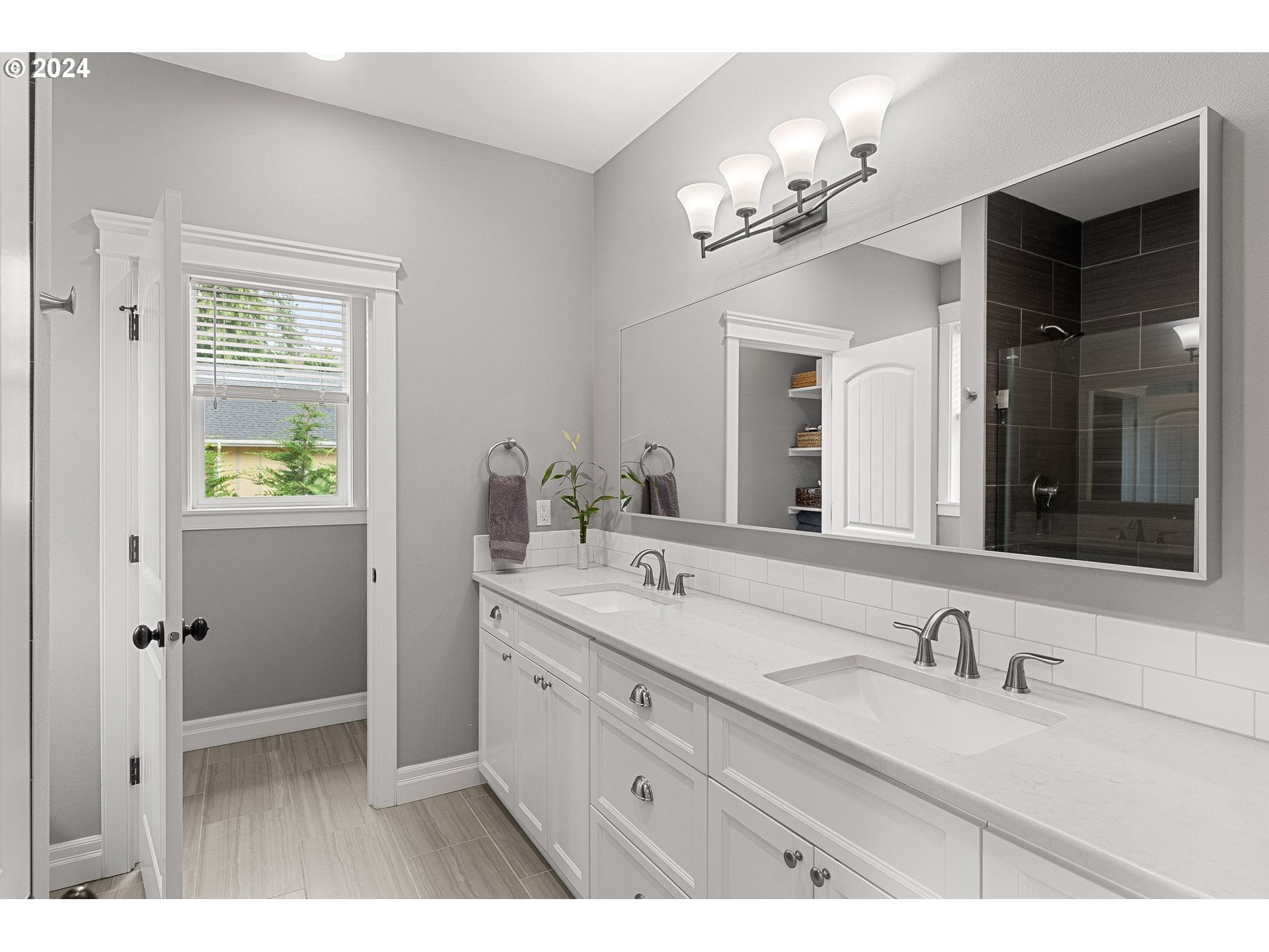 25595 South Rhoten Road Aurora, OR 97002 - Photo 23 of 48 a bathroom with a granite countertop sink a large mirror and a shower