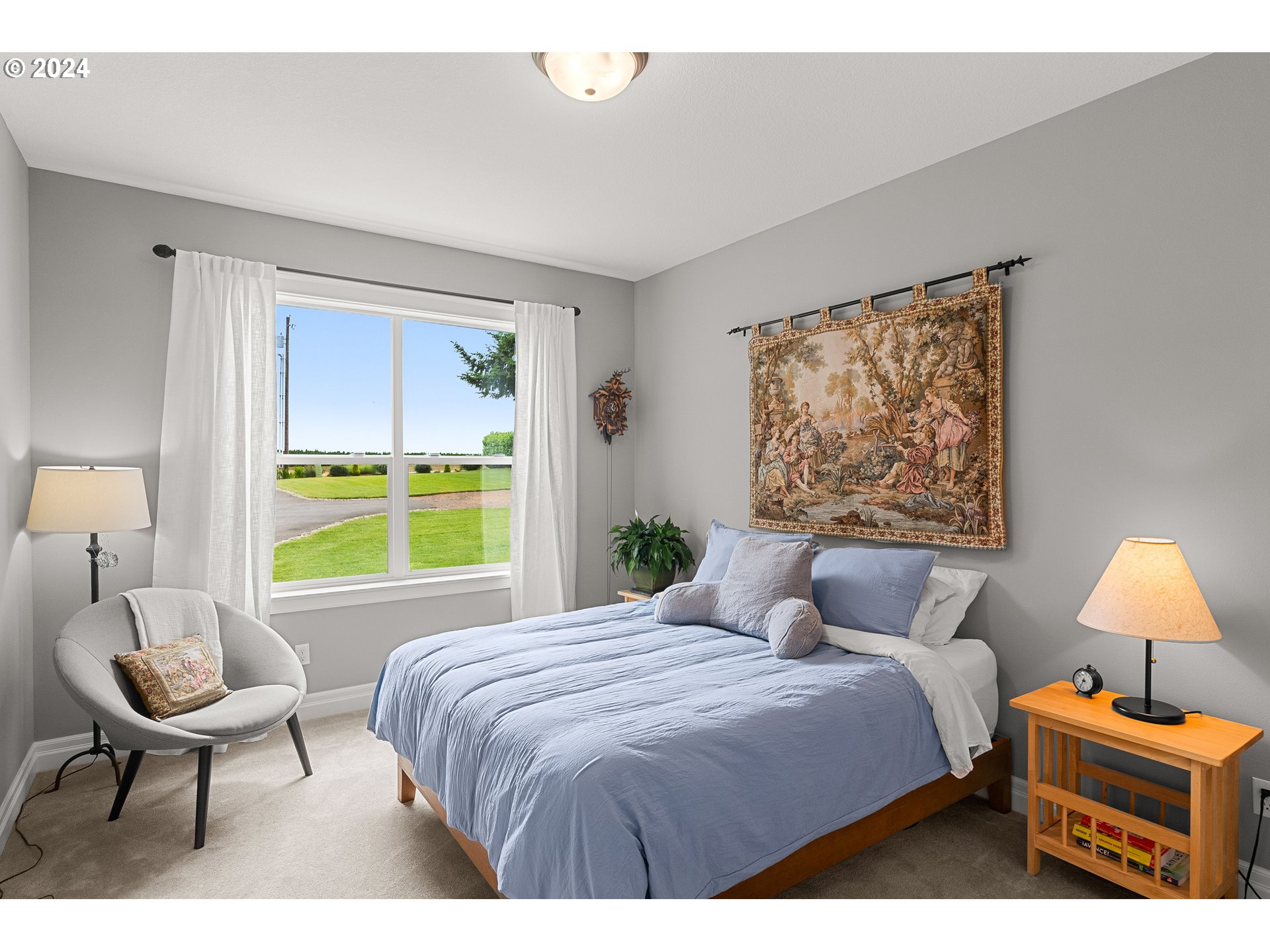 25595 South Rhoten Road Aurora, OR 97002 - Photo 25 of 48 a bedroom with a bed a couch and a window