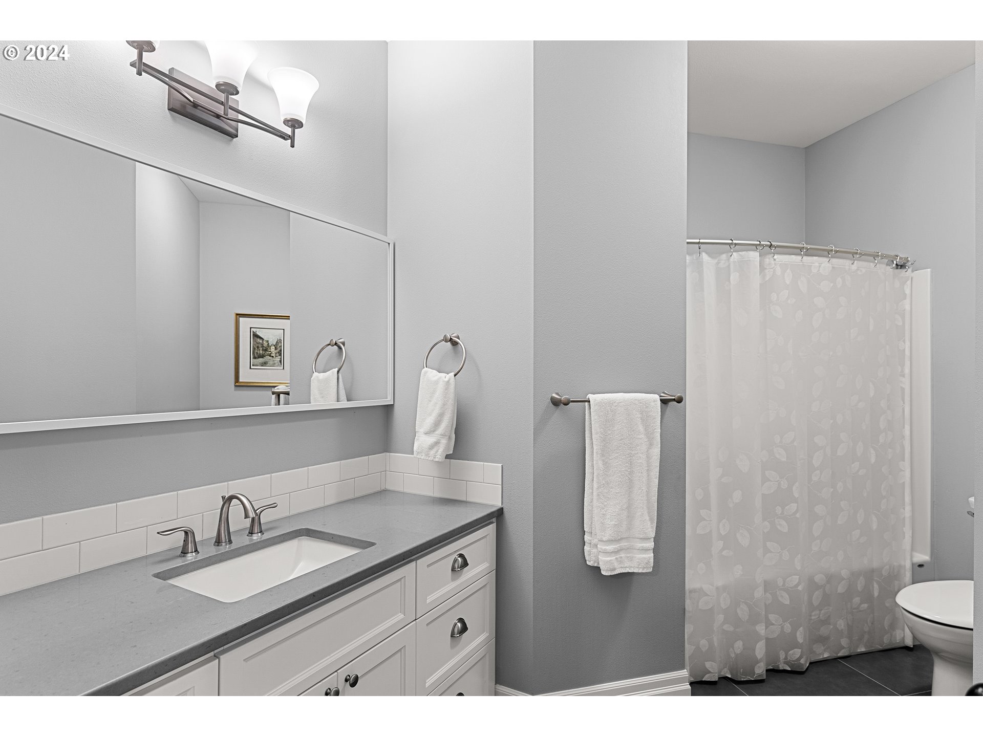 25595 South Rhoten Road Aurora, OR 97002 - Photo 26 of 48 a bathroom with a granite countertop sink a toilet and a mirror