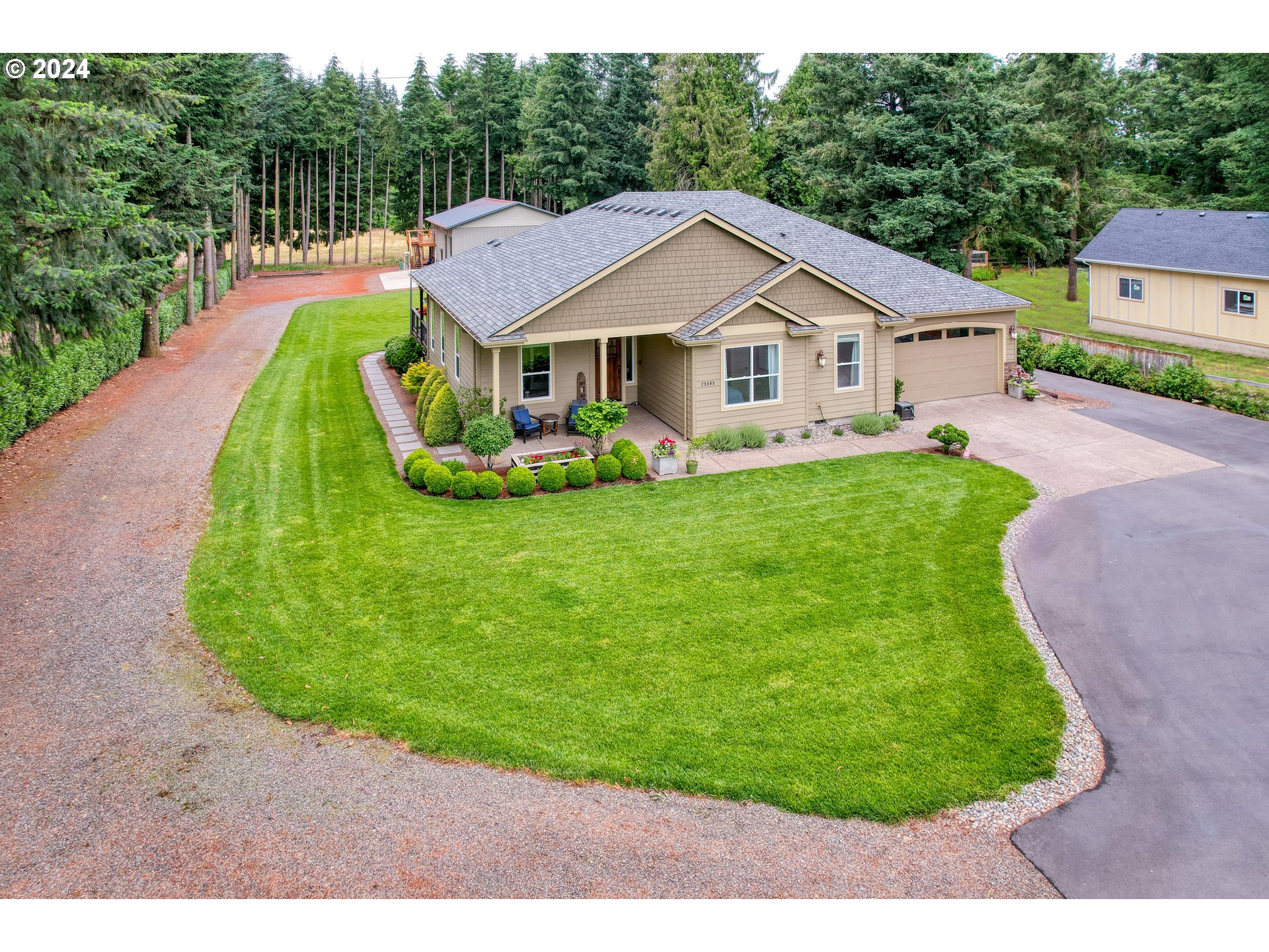 25595 South Rhoten Road Aurora, OR 97002 - Photo 28 of 48 a house with green field in front of it