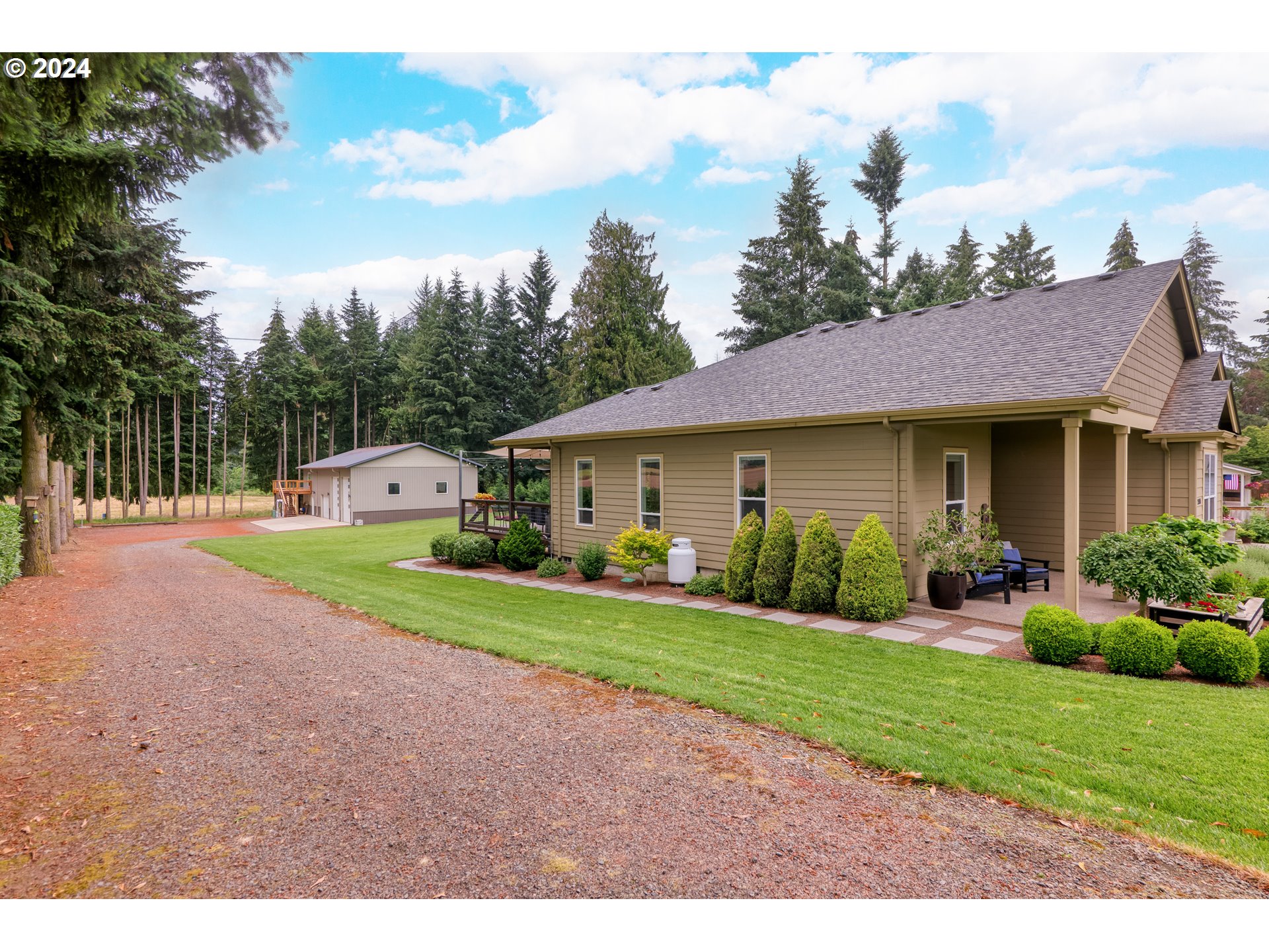25595 South Rhoten Road Aurora, OR 97002 - Photo 29 of 48 a front view of a house with a yard and garage