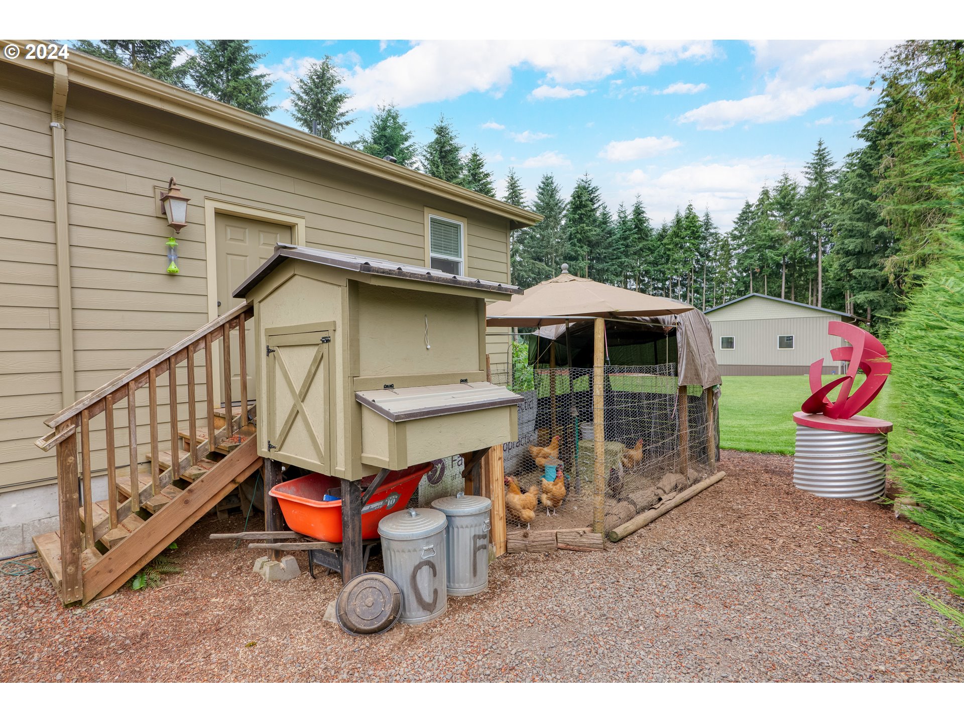 25595 South Rhoten Road Aurora, OR 97002 - Photo 36 of 48 a backyard of a house with table and chairs