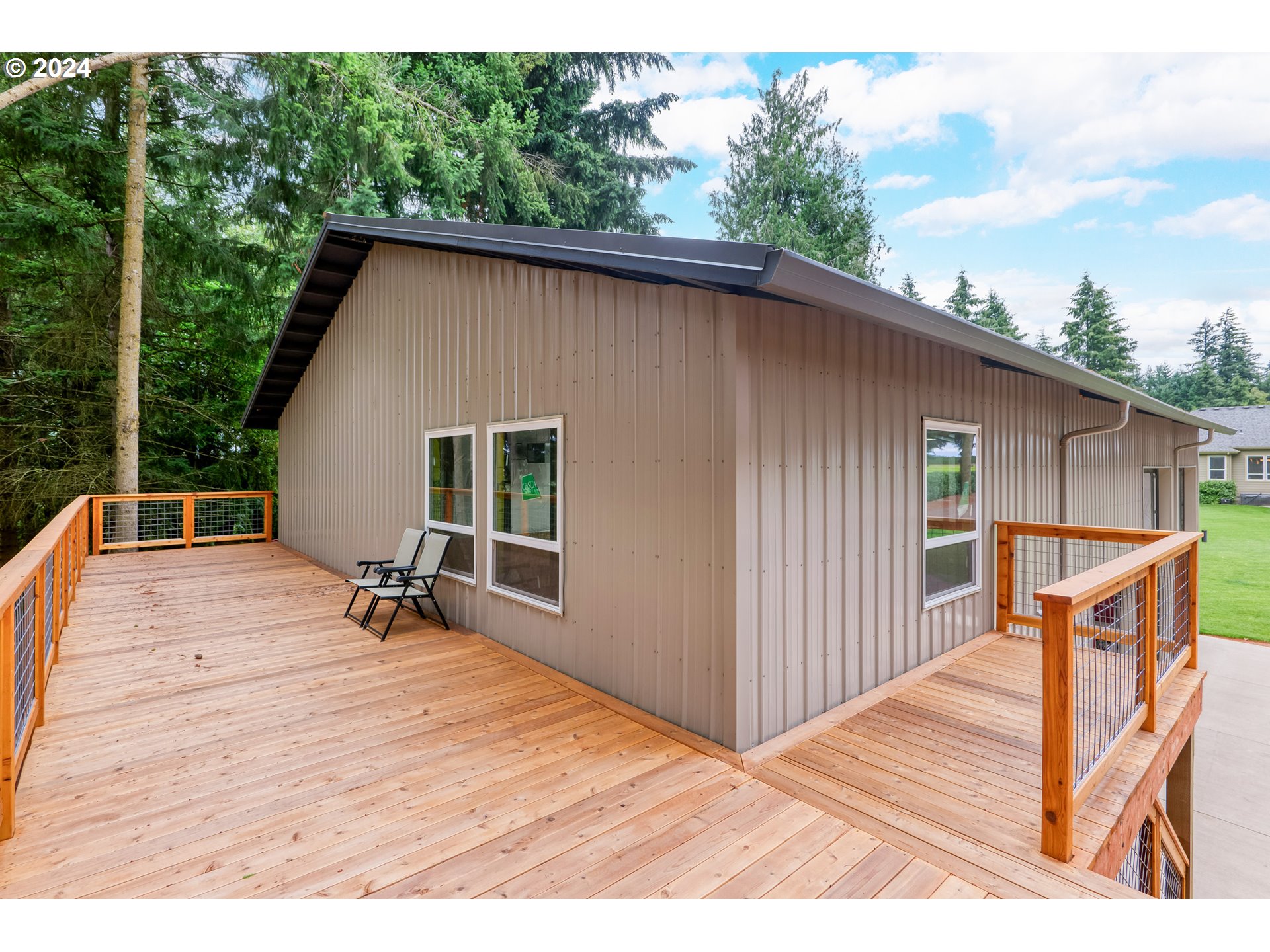 25595 South Rhoten Road Aurora, OR 97002 - Photo 40 of 48 a backyard of a house with table and chairs