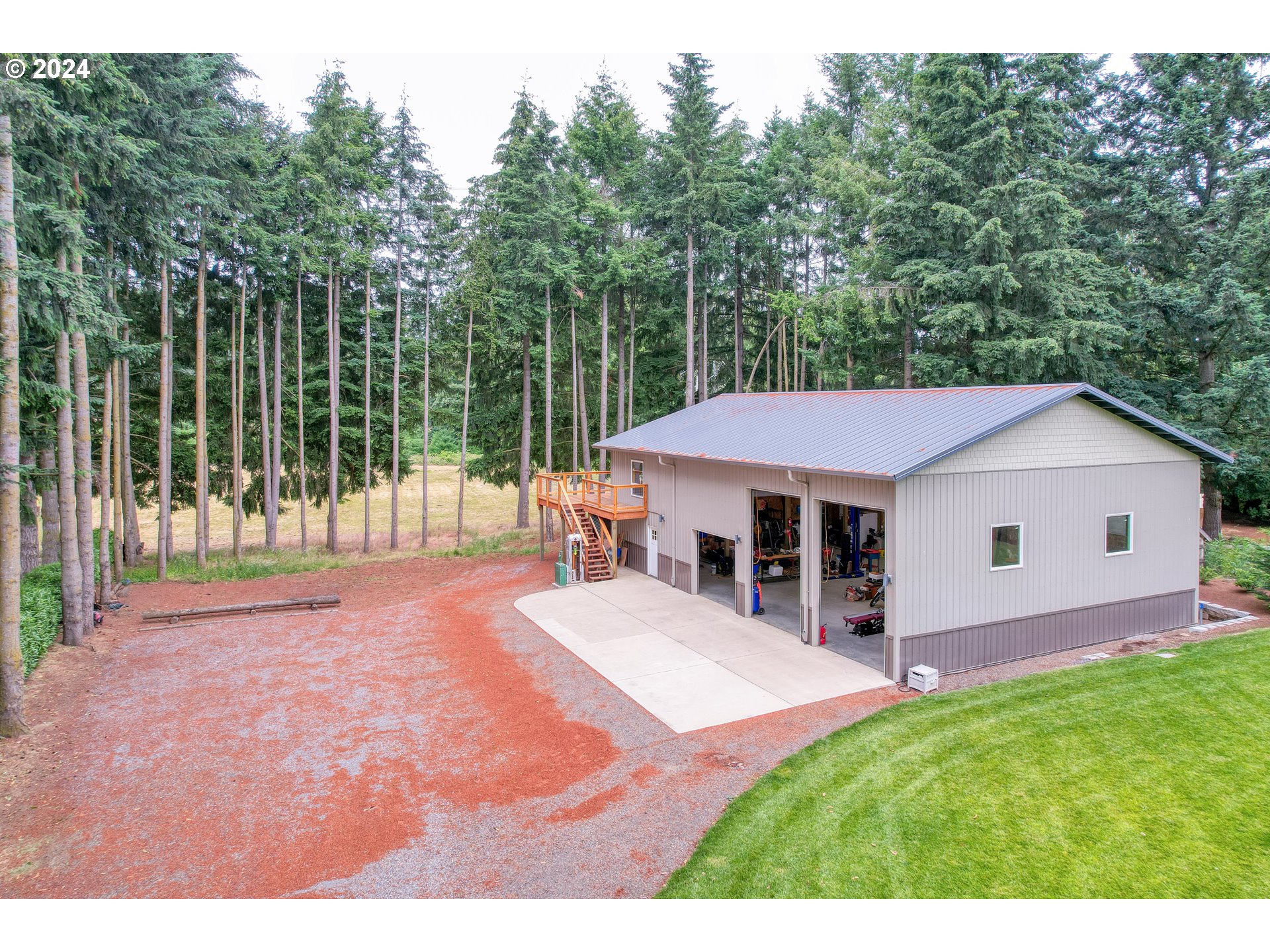 25595 South Rhoten Road Aurora, OR 97002 - Photo 42 of 48 a view of a house with a backyard and porch