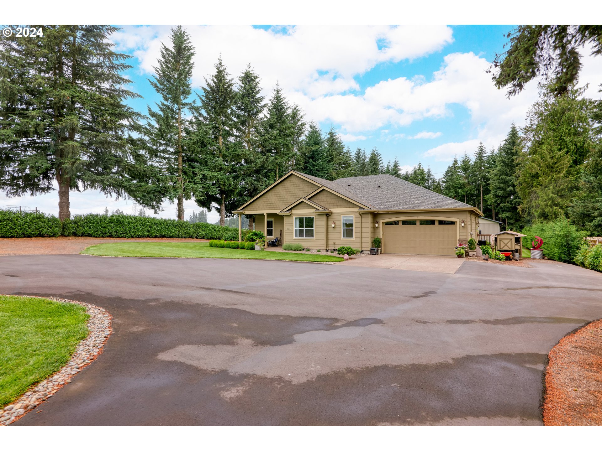 25595 South Rhoten Road Aurora, OR 97002 - Photo 5 of 48 a front view of a house with a yard and garage